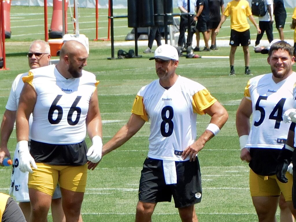 Aaron Rodgers, number 8, with Mason McCormick and Zach Frazier at Pittsburgh Steelers practice in July 2025