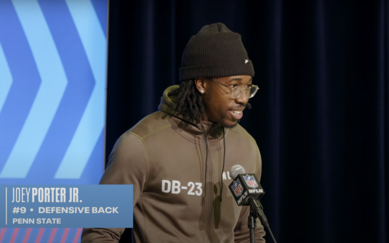 Joey Porter Jr. speaking at a microphone during the 2023 NFL Scouting Combine