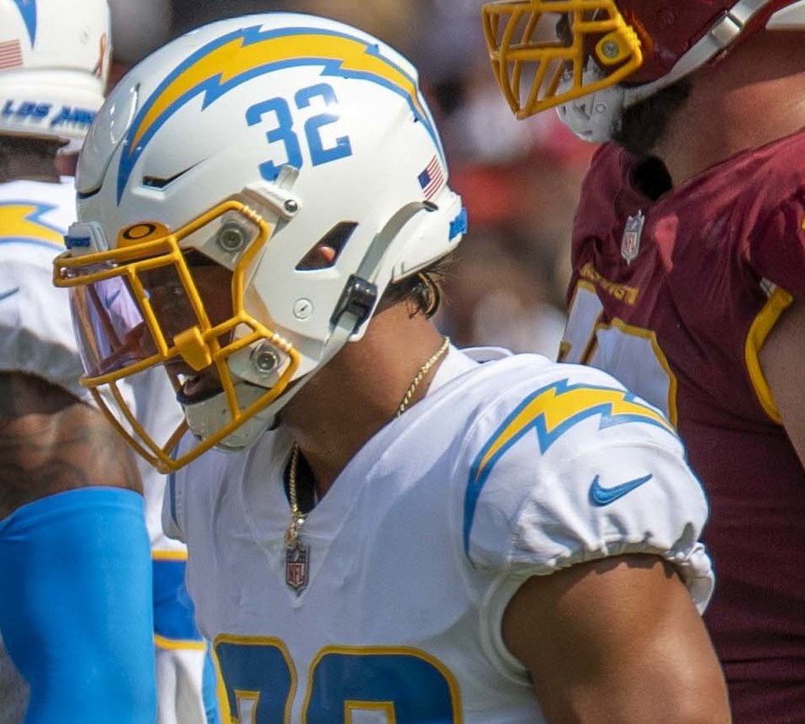 Alohi Gilman in a white Chargers jersey and helmet on the field