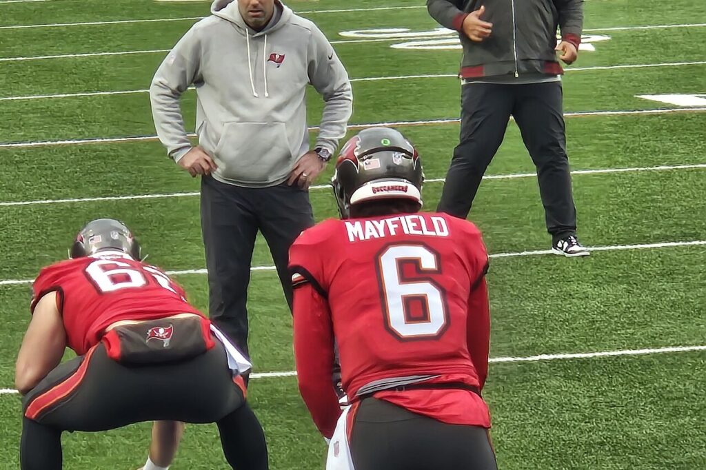 Buccaneers quarterback Baker Mayfield warms up with his center before a game