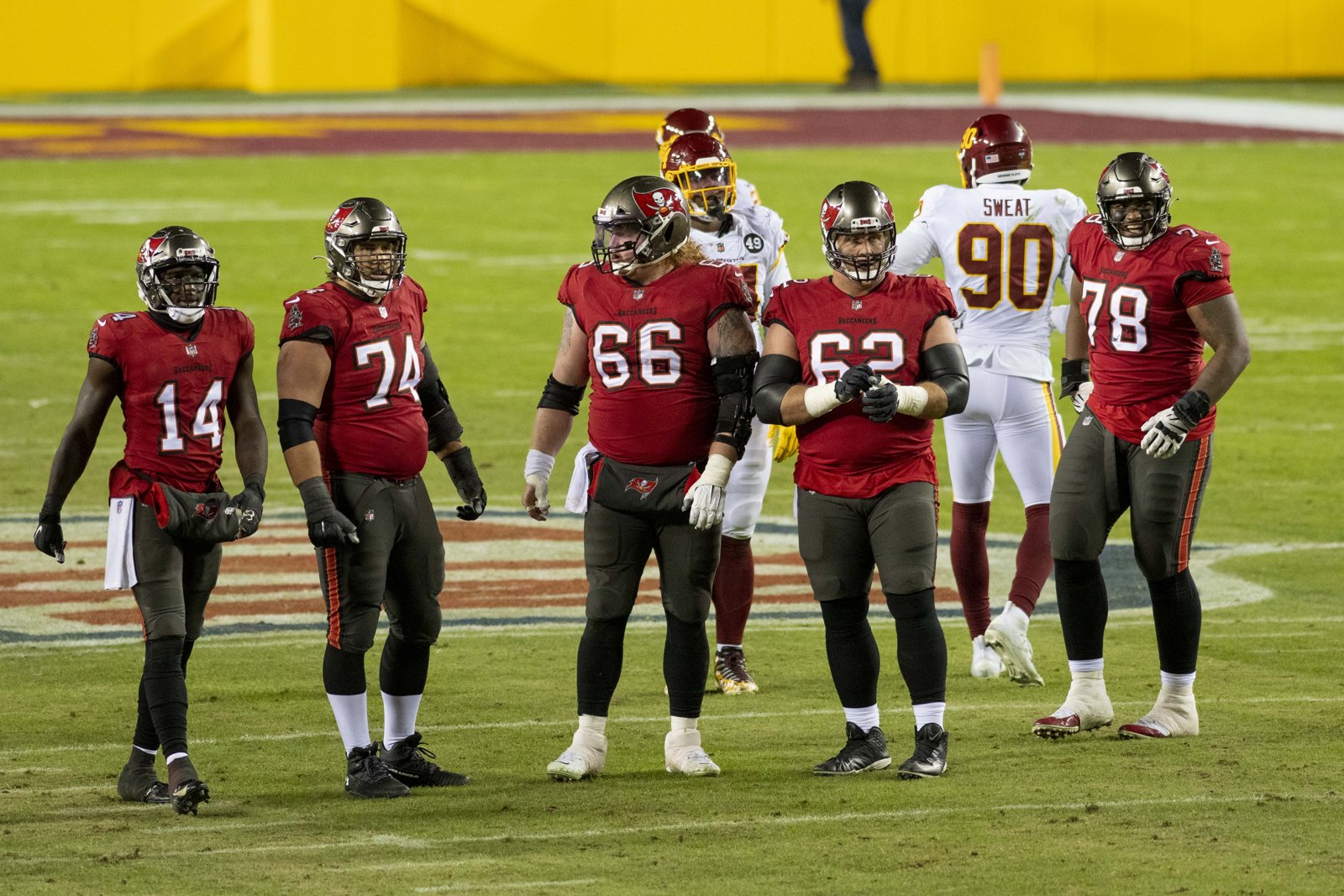 Tampa Bay Buccaneers offensive linemen walk back to the line of scrimmage