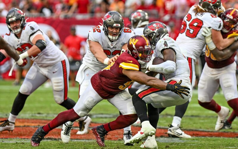 A Buccaneers running back carries the ball against Washington at Raymond James Stadium