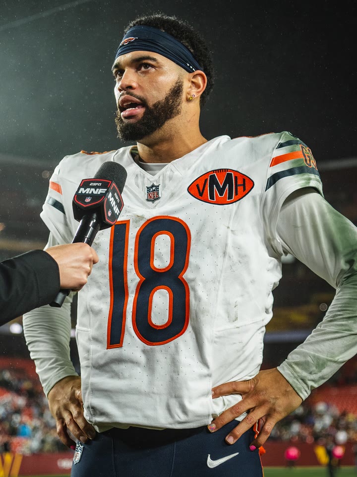 Caleb Williams in a white Chicago Bears No. 18 jersey and a headband, speaking into a microphone after a Monday night game