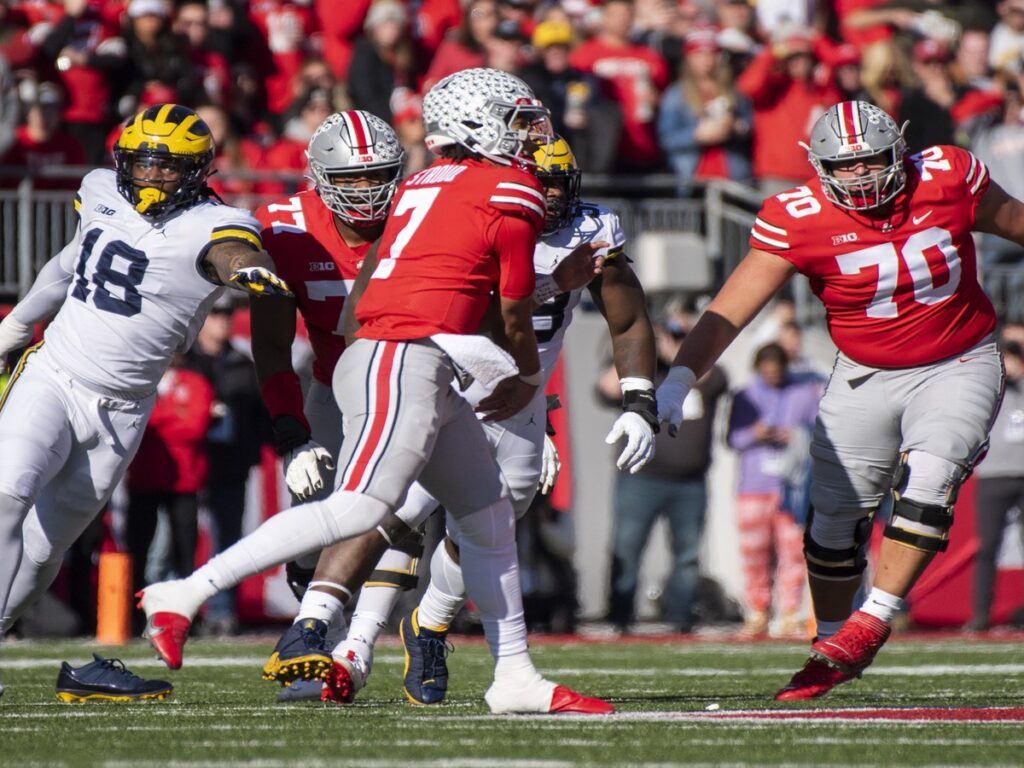 C.J. Stroud in an Ohio State uniform dropping back to pass