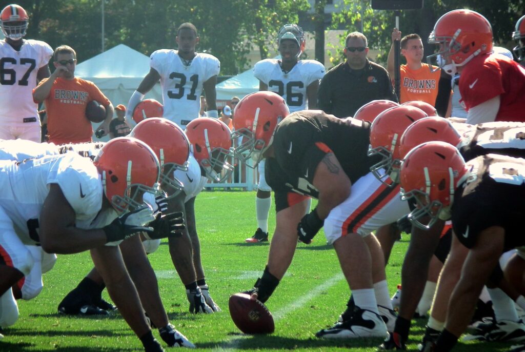 Cleveland Browns offensive and defensive linemen set in three-point stances on either side of the football at the line of scrimmage
