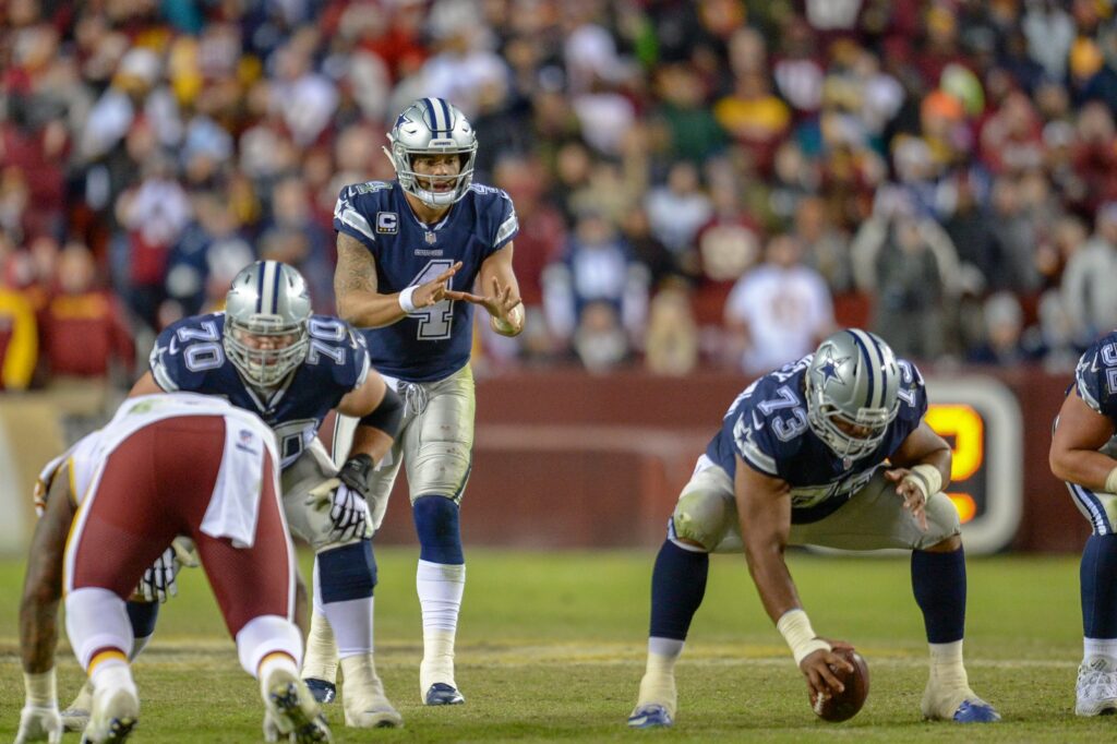 Dallas Cowboys quarterback Dak Prescott in shotgun behind center at the line of scrimmage against Washington