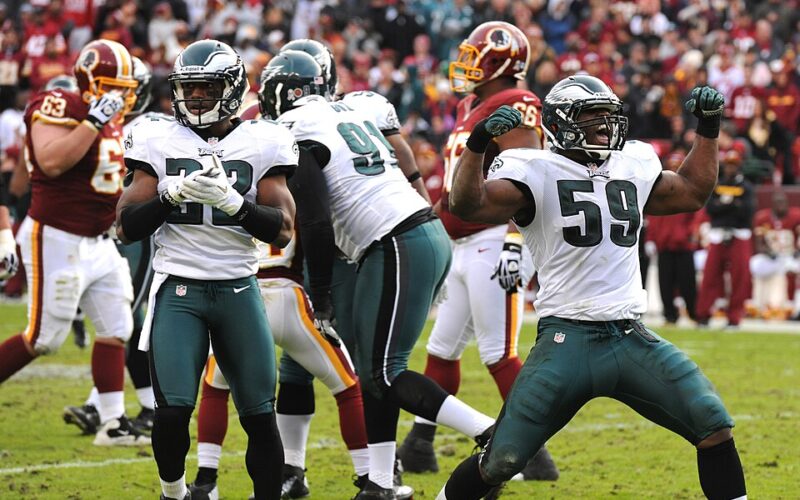 DeMeco Ryans, number 59 at right, celebrates as a Philadelphia Eagles linebacker in a 2012 game against Washington.