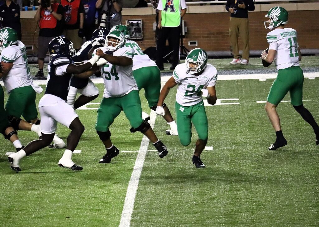 Drew Mestemaker, wearing No. 11 for North Texas, drops back to pass at Rice Stadium in November 2025.