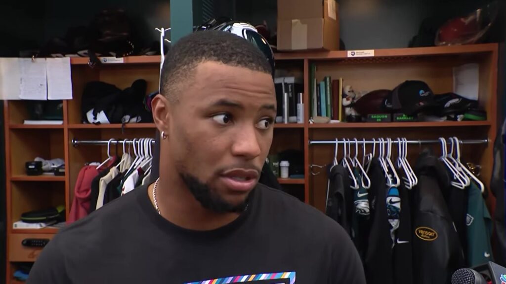 Eagles running back Saquon Barkley speaks to reporters in the locker room before the Commanders game