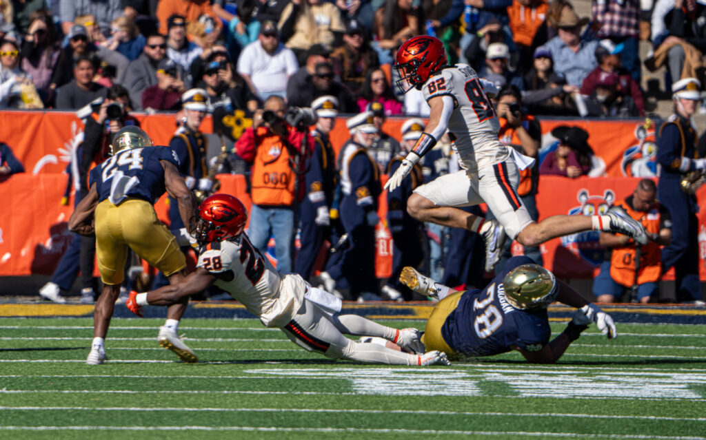 Notre Dame running back Jadarian Price, number 24, is approached by Oregon State defenders during the 2023 Sun Bowl.