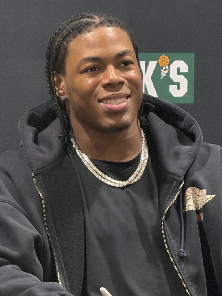Jahmyr Gibbs smiling at an autograph signing