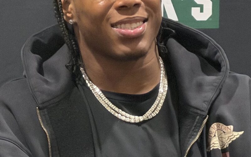 Jahmyr Gibbs smiling at an autograph signing