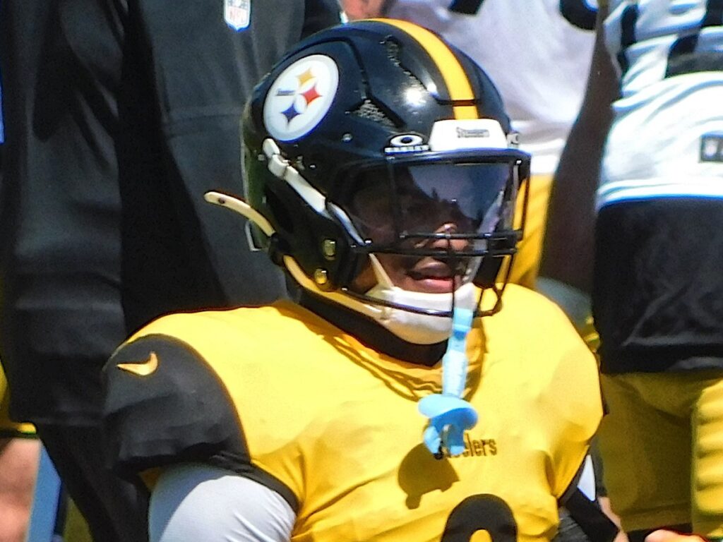 Jaquan Brisker in a gold Steelers practice jersey and helmet at training camp