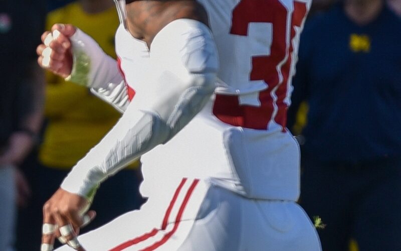 Jihaad Campbell in an Alabama crimson jersey and helmet looking downfield