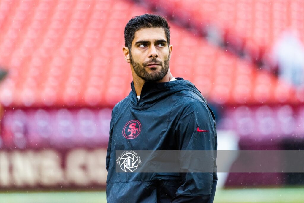 Jimmy Garoppolo in a 49ers jacket on the field before a game at Washington in October 2019