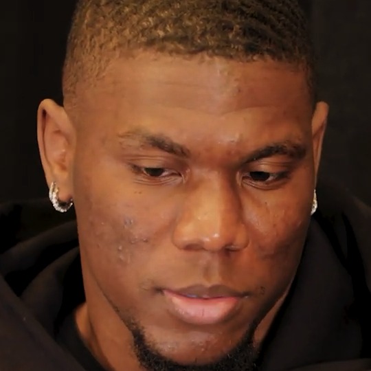 Keion White in a dark hooded sweatshirt during an interview