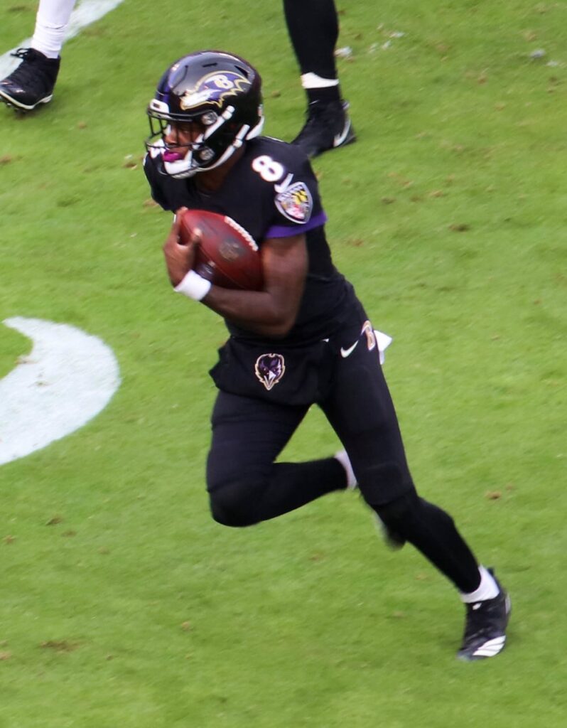 Lamar Jackson runs with the ball for the Baltimore Ravens against the Cincinnati Bengals in 2018