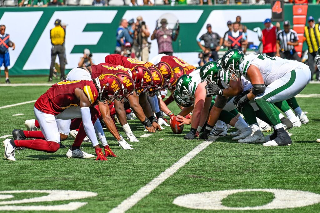 Washington Commanders and New York Jets linemen set at the line of scrimmage before a snap at MetLife Stadium
