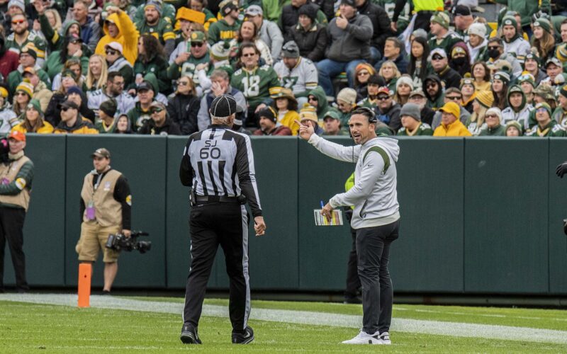 Matt LaFleur gestures toward an official on the sideline at Lambeau Field