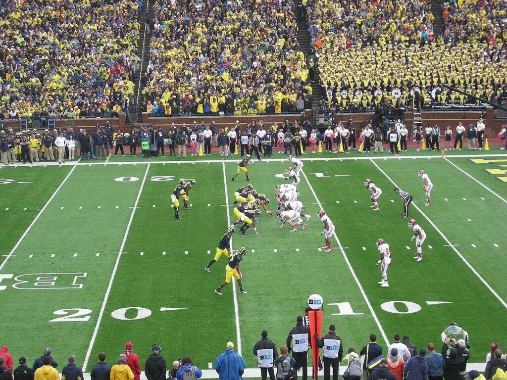 Michigan on offense against Indiana at Michigan Stadium, with fans in maize filling the stands
