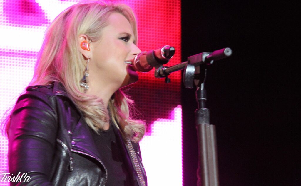 Miranda Lambert sings into a microphone on stage
