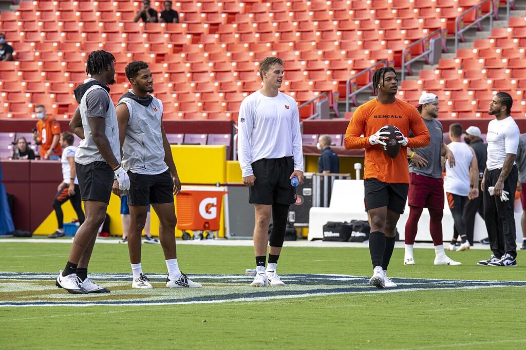 Ja’Marr Chase in an orange shirt alongside Joe Burrow and Cincinnati teammates before an August 2021 preseason game.
