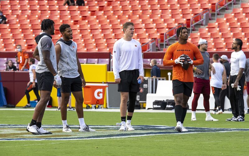 Ja’Marr Chase in an orange shirt alongside Joe Burrow and Cincinnati teammates before an August 2021 preseason game.