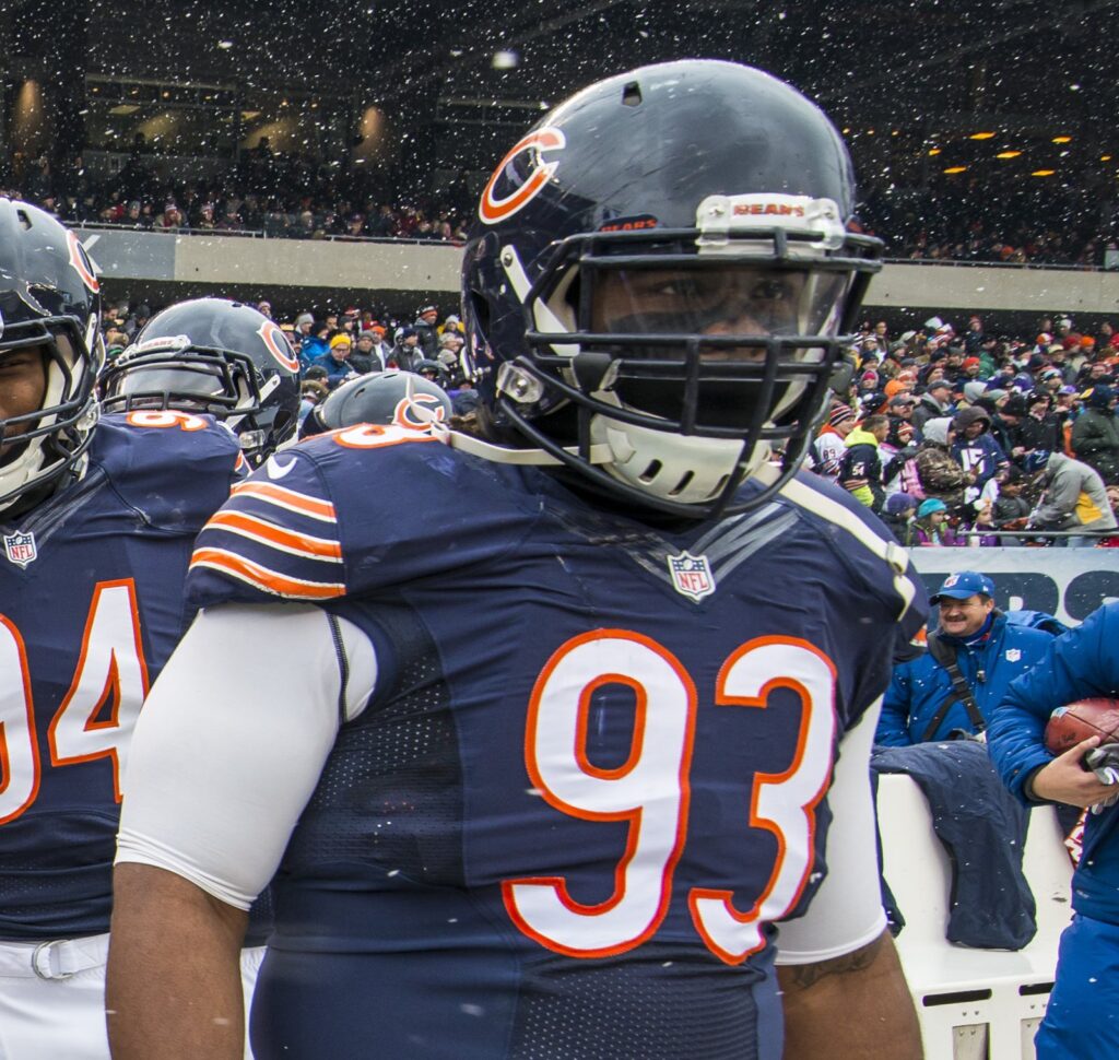 Chicago Bears defensive tackle Will Sutton in a navy helmet with a face mask, standing on the field in falling snow