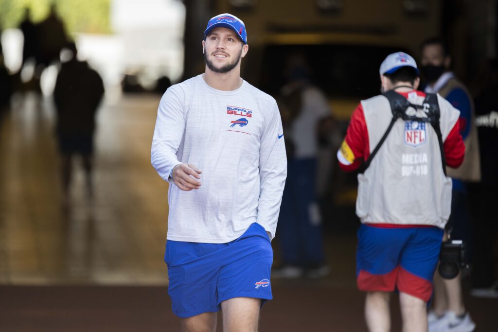 Josh Allen wearing Buffalo Bills training clothes and a cap before a September 2021 game.