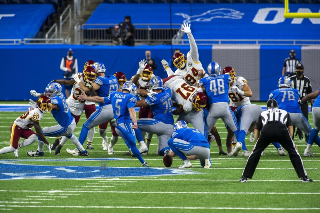 Washington defenders leap to contest a Detroit Lions field-goal attempt at Ford Field
