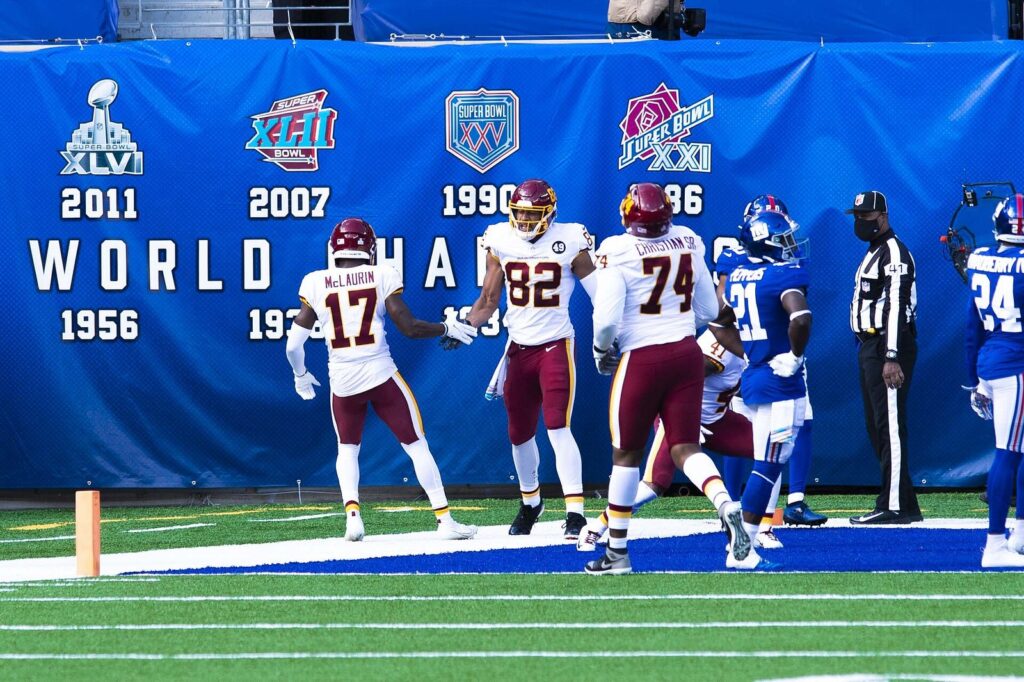 Washington players celebrate a touchdown in the end zone at MetLife Stadium as an official watches
