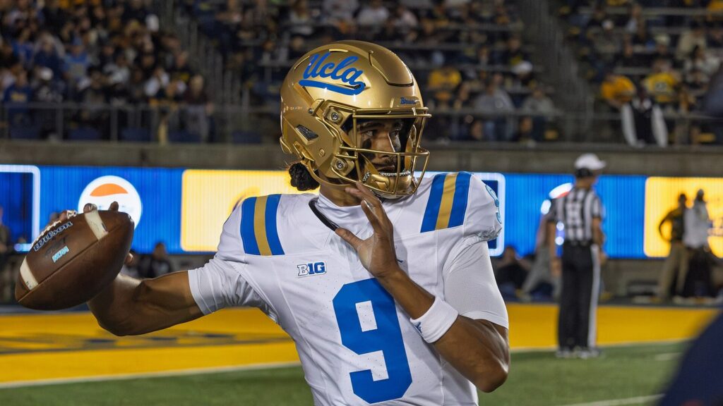 UCLA quarterback Nico Iamaleava, No. 9, in a gold helmet and white jersey, sets to throw at California on September 5, 2026.