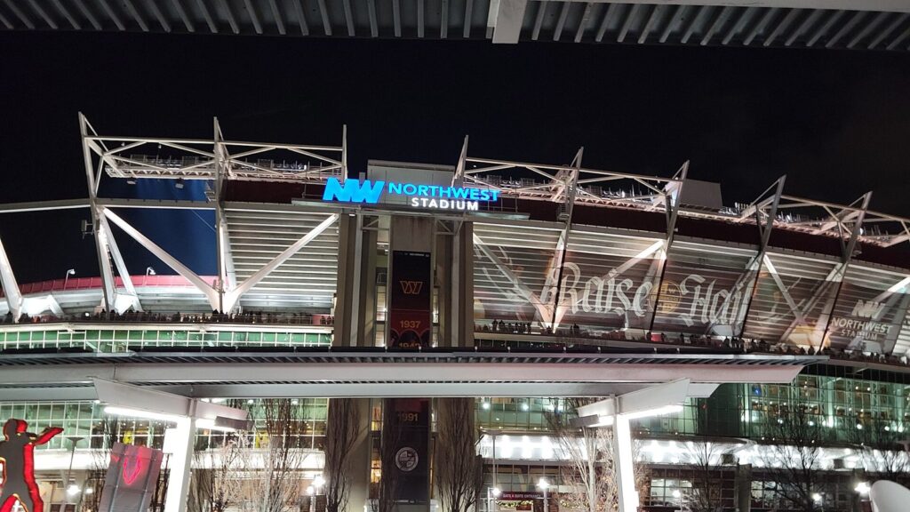 Northwest Stadium in Landover, Maryland, lit up at night before a Washington Commanders game