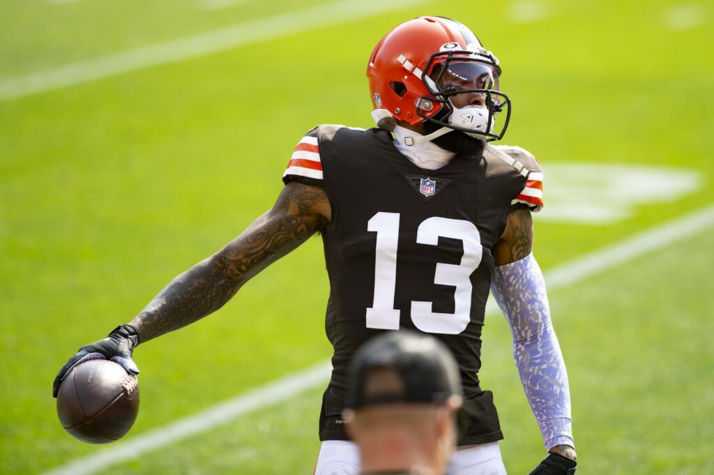 Odell Beckham Jr. wearing Cleveland’s No. 13 uniform and holding a football during a September 2020 game against Washington.