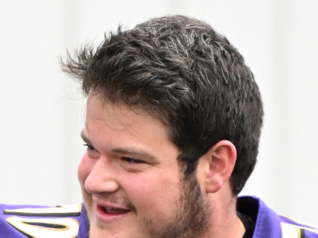 Roger Rosengarten smiling in a purple Ravens No. 70 practice jersey