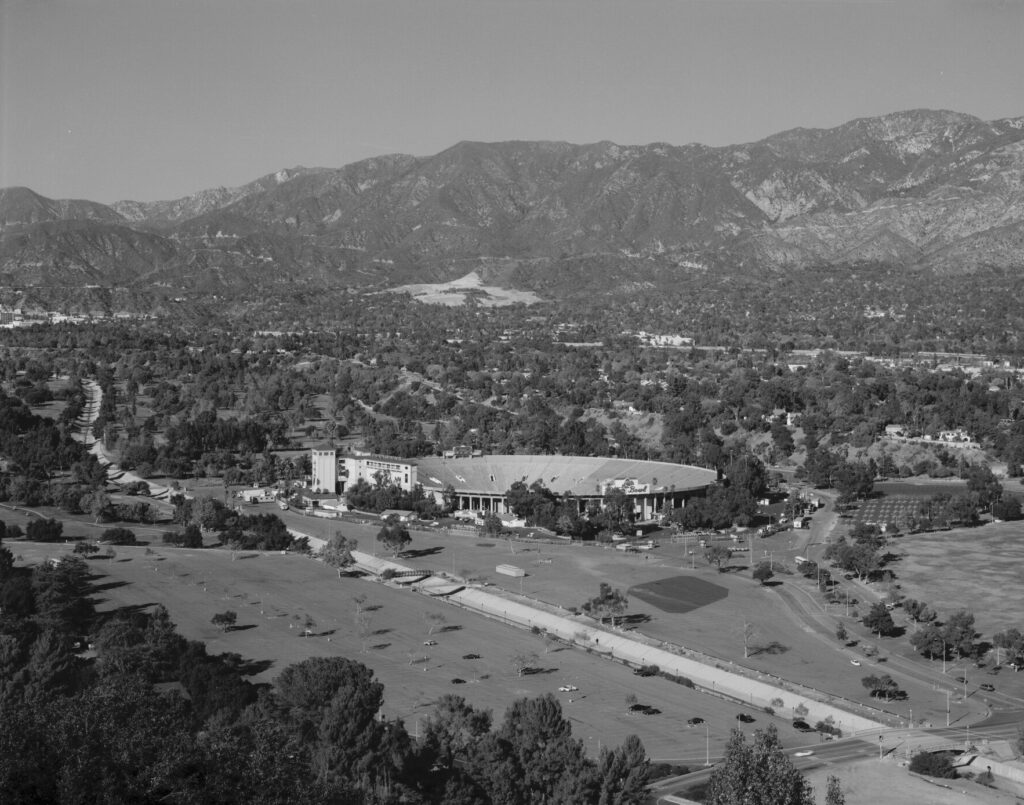 Aerial view of Rose Bowl Stadium in Pasadena with the San Gabriel Mountains behind it