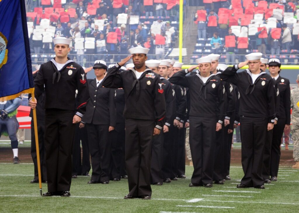 Sailors salute during the national anthem at a Seahawks Military Appreciation Day game