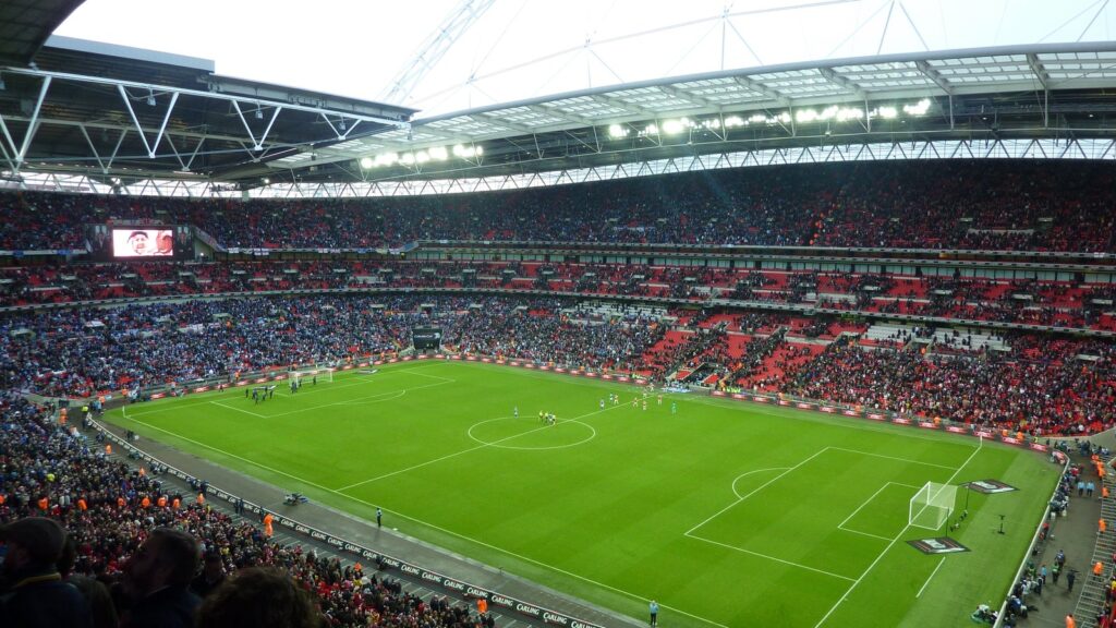 Wembley Stadium exterior with arch under cloudy sky