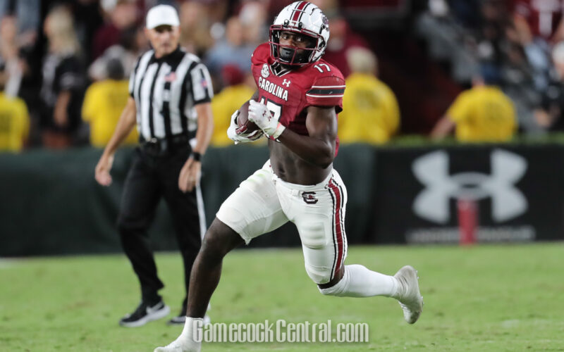 Xavier Legette runs with a football in South Carolina's garnet number 17 jersey and white helmet during a September 2023 game.