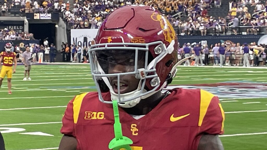 Zachariah Branch in a red USC No. 1 jersey and helmet on the field